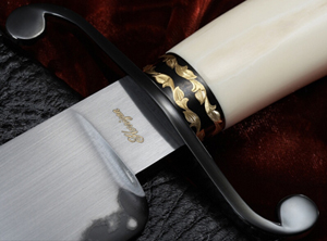 Close up of the Elite Knives Ivory Bowie knife with gold work on ferrel